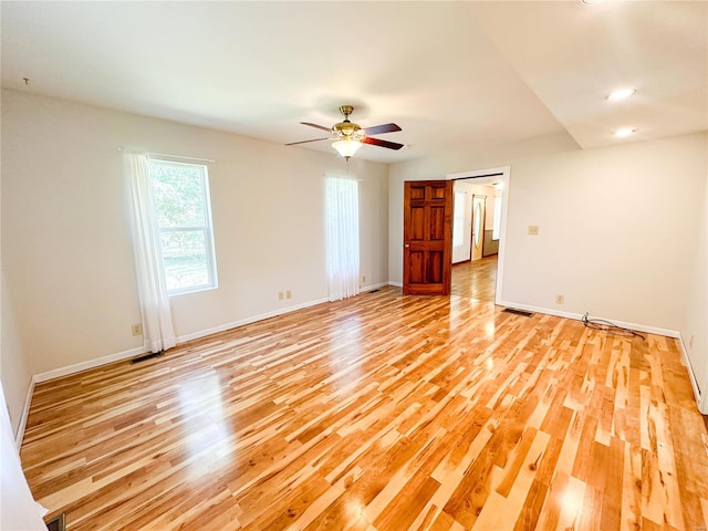 empty room featuring light wood-type flooring and ceiling fan