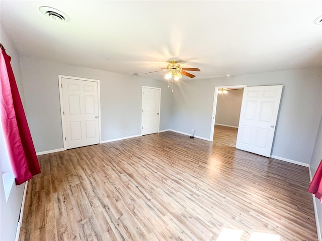 unfurnished bedroom with ceiling fan and hardwood / wood-style flooring