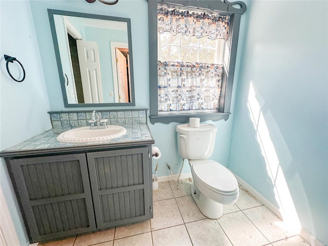 bathroom with tile patterned flooring, toilet, and vanity