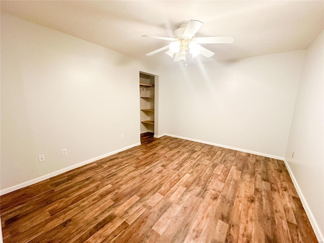 empty room with light wood-type flooring and ceiling fan