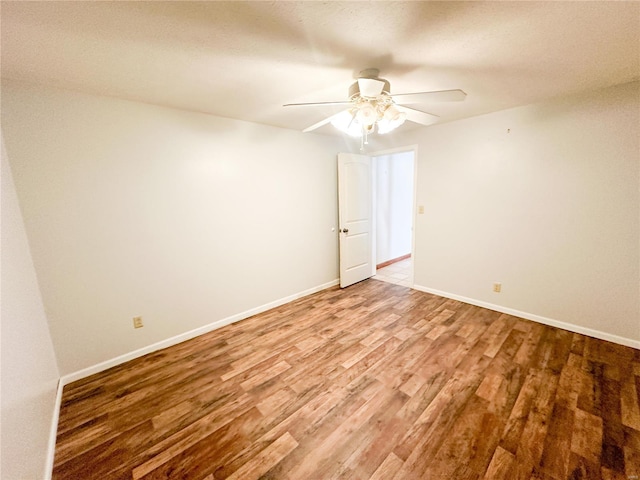 spare room featuring ceiling fan and wood-type flooring