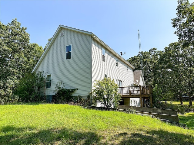 view of home's exterior with a yard and a wooden deck