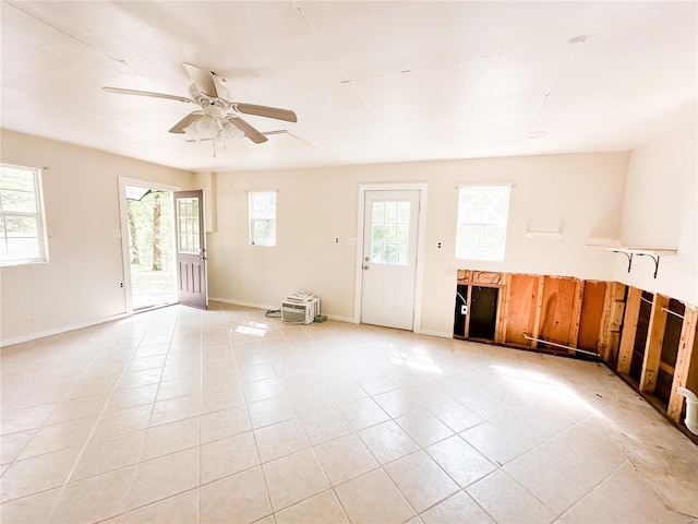 tiled empty room with ceiling fan