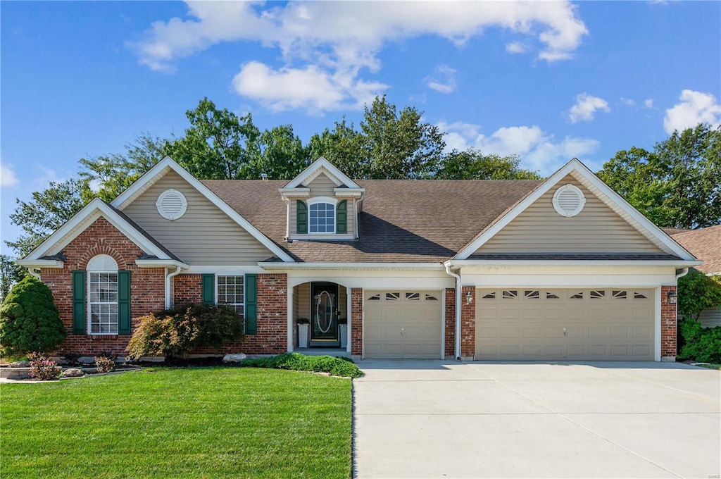 view of front of house featuring a front yard and a garage