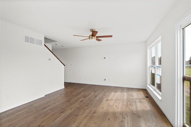 unfurnished living room featuring visible vents, baseboards, ceiling fan, and wood finished floors