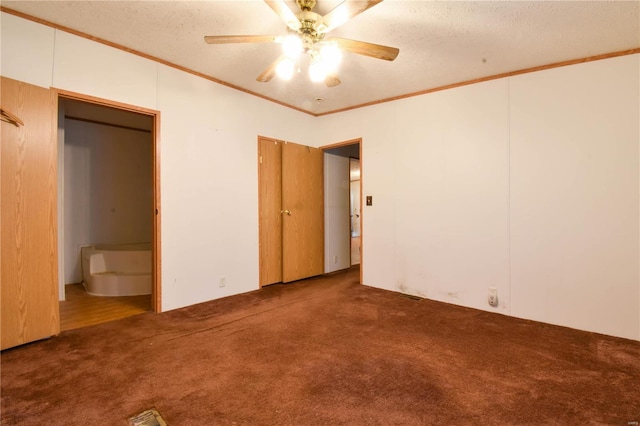 unfurnished bedroom with ceiling fan, a textured ceiling, carpet floors, and crown molding