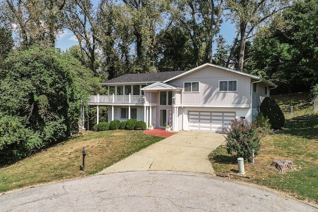 view of front of home with a garage and a front lawn