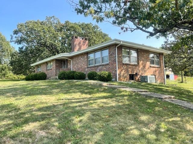 ranch-style house with a front lawn and central AC unit