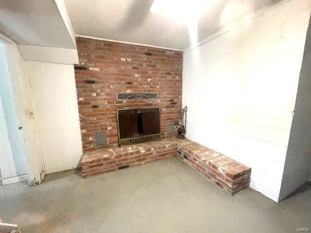 unfurnished living room with concrete flooring