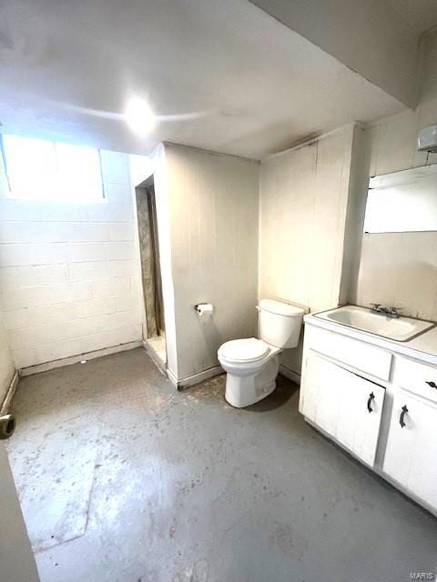 bathroom with walk in shower, vanity, toilet, and concrete floors