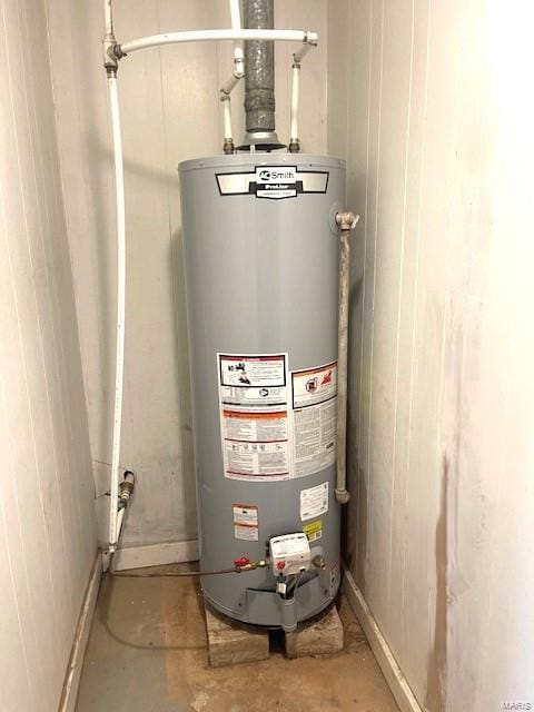 utility room featuring gas water heater