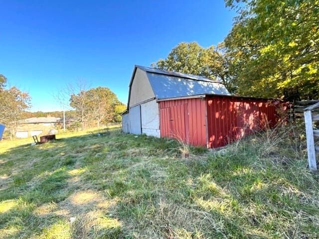 view of outbuilding with a lawn