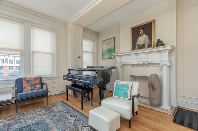 living area with hardwood / wood-style flooring and ornate columns