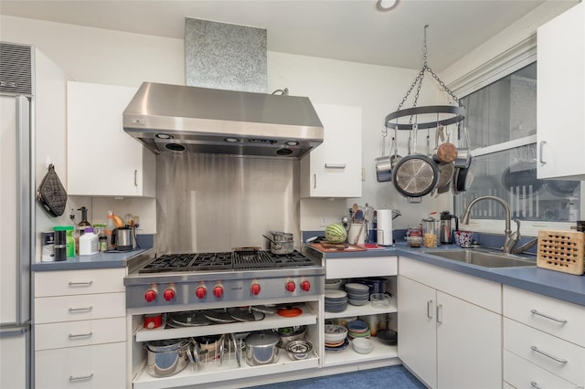 kitchen with island exhaust hood, stainless steel appliances, sink, and white cabinets