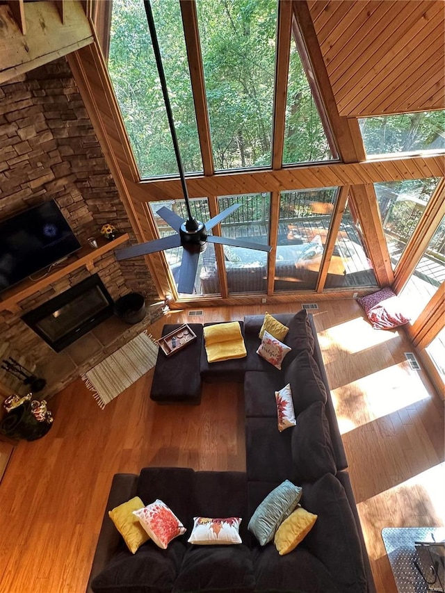 unfurnished living room featuring ceiling fan and wooden walls