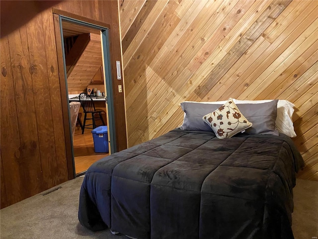 bedroom with wood walls, a closet, and carpet