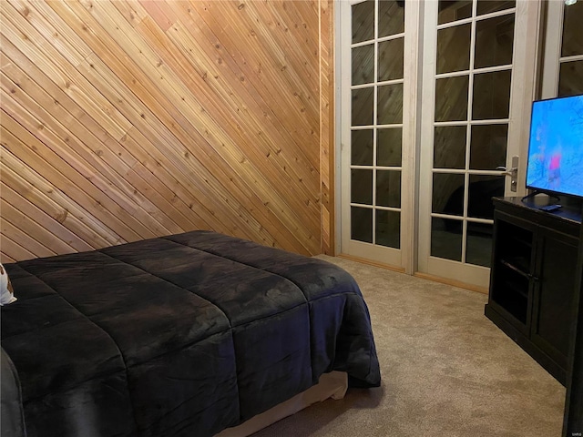 bedroom with wood walls and carpet flooring