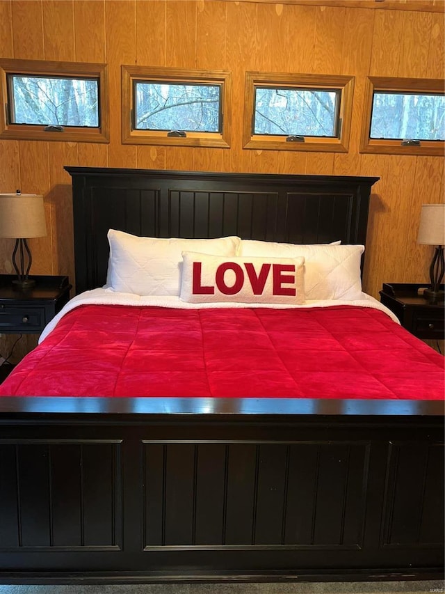 bedroom featuring wooden walls