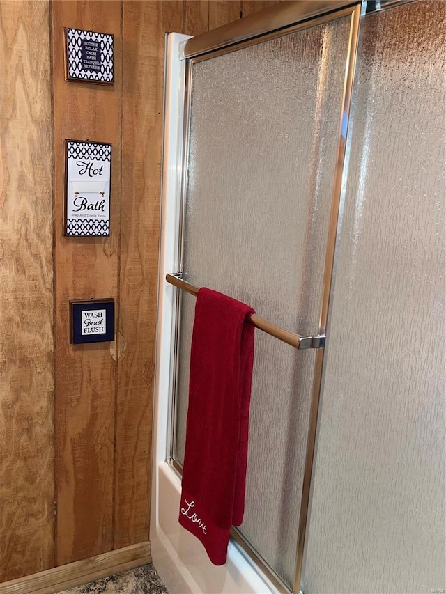 bathroom featuring shower / bath combination with glass door