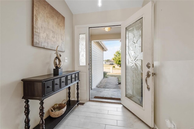 foyer entrance featuring vaulted ceiling