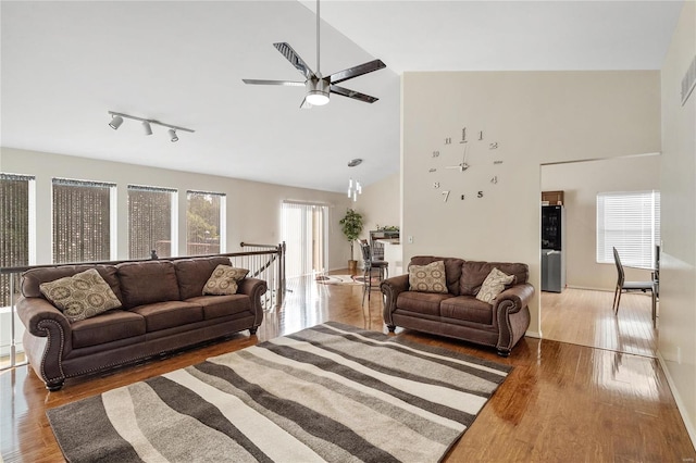 living room featuring track lighting, high vaulted ceiling, hardwood / wood-style flooring, and ceiling fan