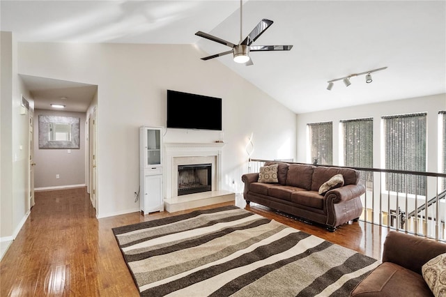 living room with a fireplace, a wealth of natural light, hardwood / wood-style floors, and ceiling fan