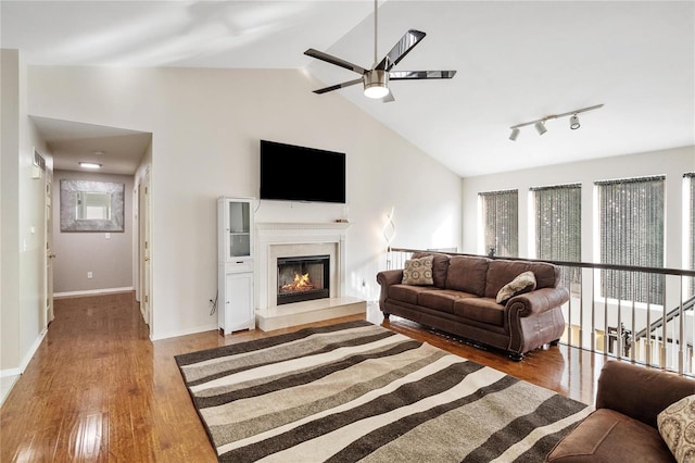 living room featuring lofted ceiling, a healthy amount of sunlight, ceiling fan, and hardwood / wood-style flooring