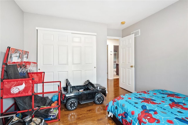 bedroom featuring hardwood / wood-style flooring and a closet