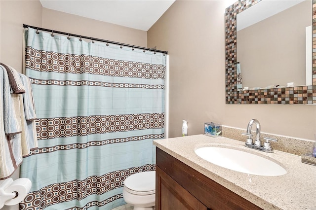 bathroom with a shower with shower curtain, toilet, and vanity