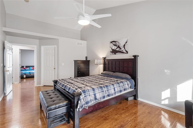 bedroom with lofted ceiling, ceiling fan, and hardwood / wood-style flooring