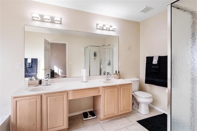 bathroom featuring tile patterned floors, toilet, a shower with door, and vanity