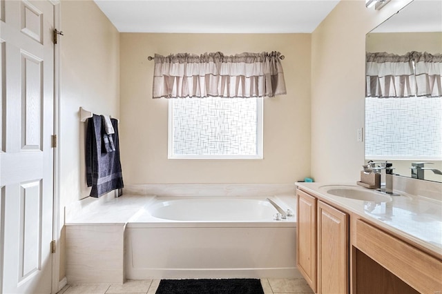 bathroom featuring tile patterned flooring, a washtub, and vanity