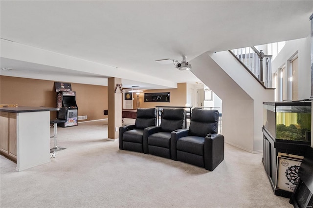 home theater room featuring light carpet and ceiling fan