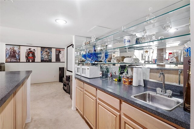 bar featuring sink and light brown cabinets