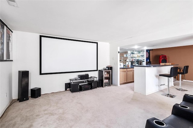 cinema featuring light colored carpet and bar