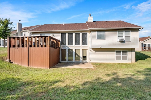 rear view of property featuring a lawn and cooling unit