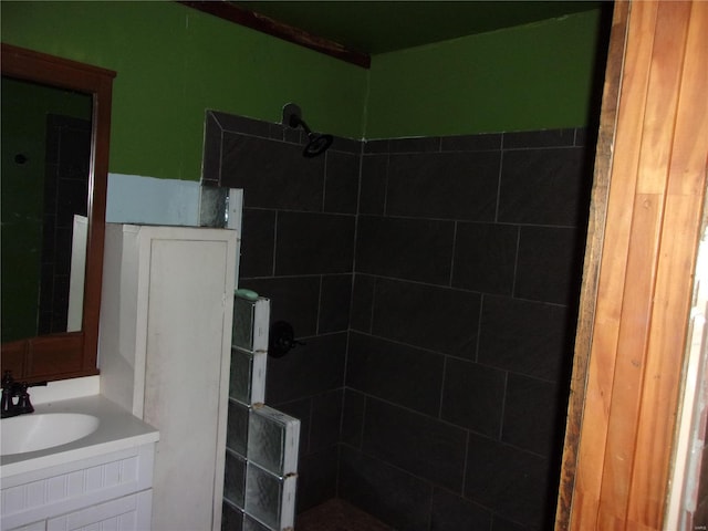 bathroom with vanity and a tile shower