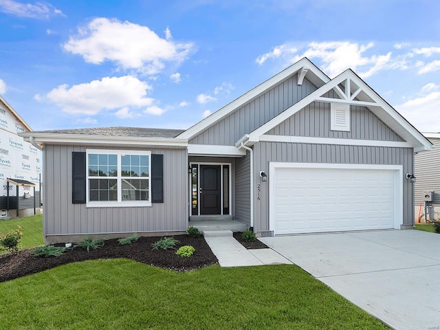 view of front of property featuring a garage and a front yard