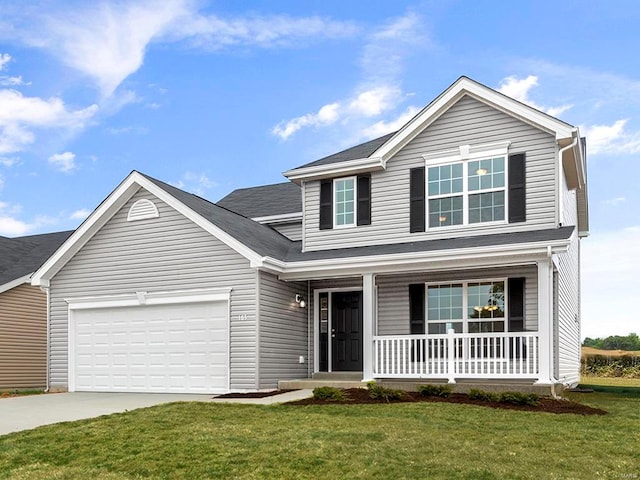 front of property featuring a garage, a front yard, and covered porch