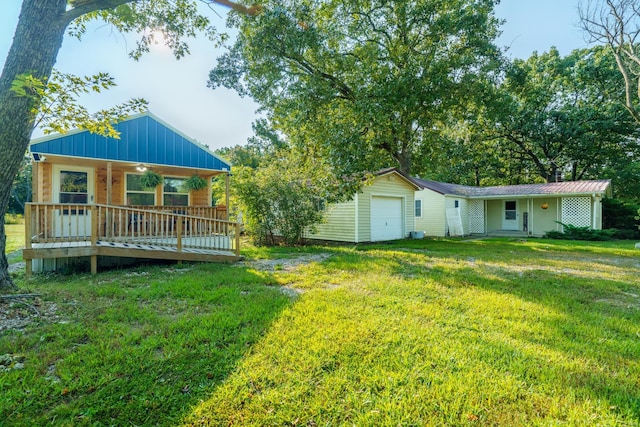 back of house with a yard and covered porch