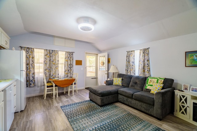 living room with lofted ceiling and light hardwood / wood-style floors