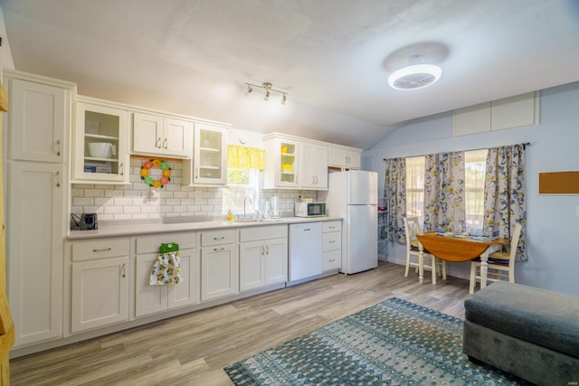 kitchen with light wood-type flooring, sink, white appliances, and white cabinetry