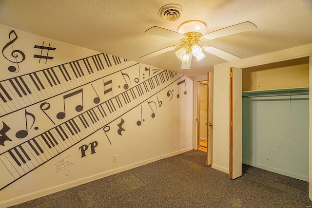 interior space with a closet, ceiling fan, carpet, and a textured ceiling