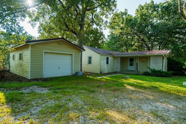 single story home featuring a garage and a front yard