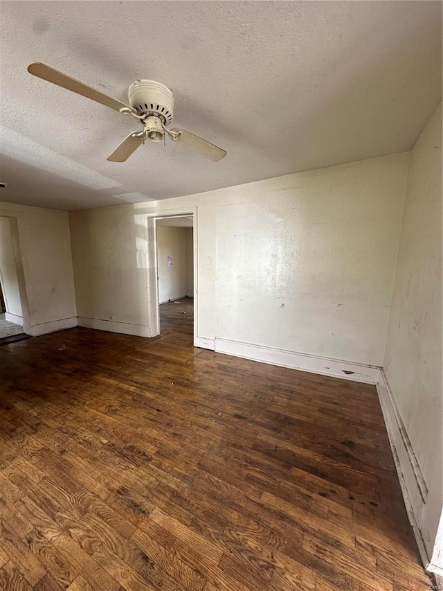 spare room featuring a textured ceiling, ceiling fan, and dark hardwood / wood-style floors