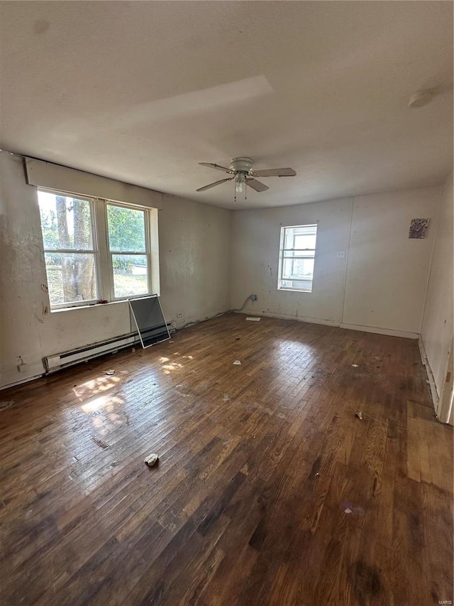 empty room with dark hardwood / wood-style flooring and ceiling fan