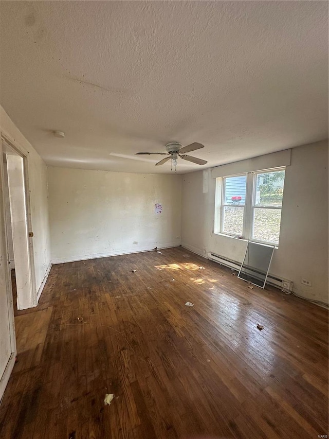 unfurnished room with ceiling fan, baseboard heating, dark hardwood / wood-style flooring, and a textured ceiling