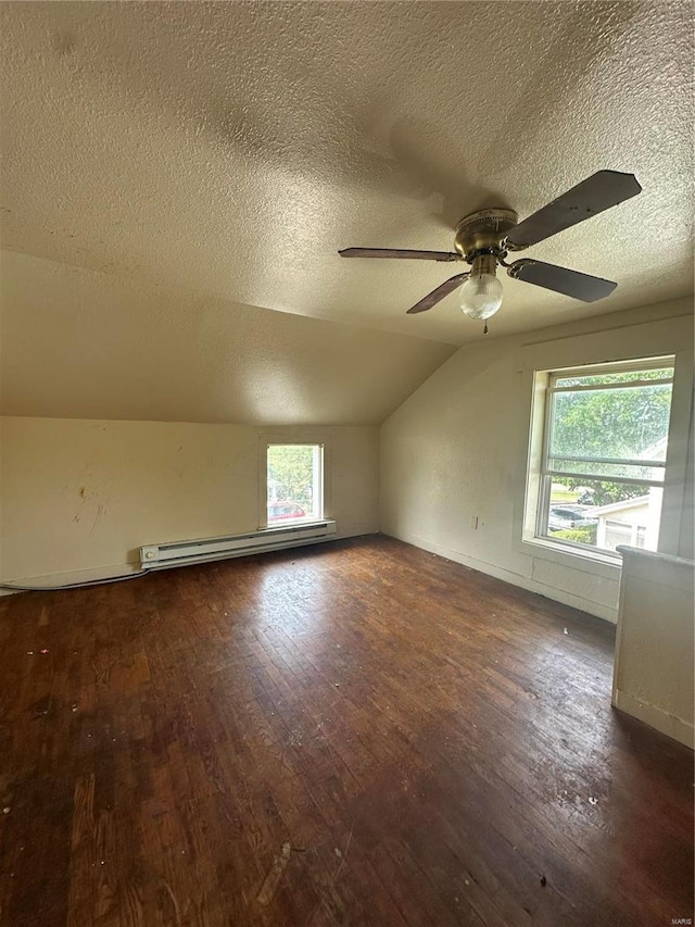 additional living space featuring a textured ceiling, ceiling fan, dark hardwood / wood-style flooring, and lofted ceiling