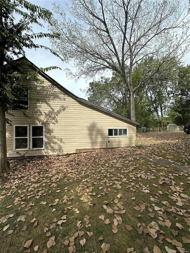 view of property exterior featuring a storage shed