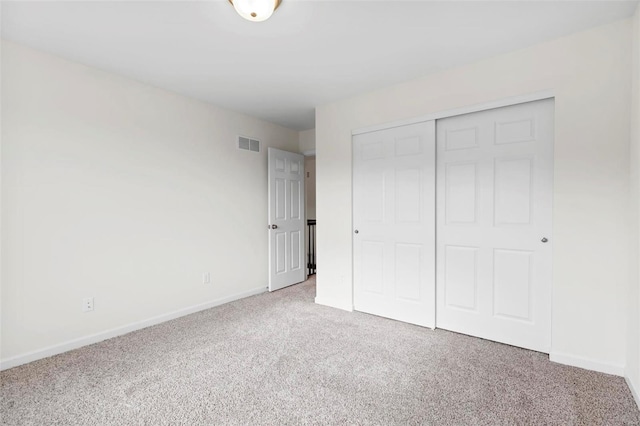 unfurnished bedroom featuring carpet and a closet